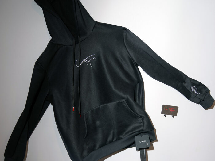 Black hooded sweatshirt with embroidered logo.