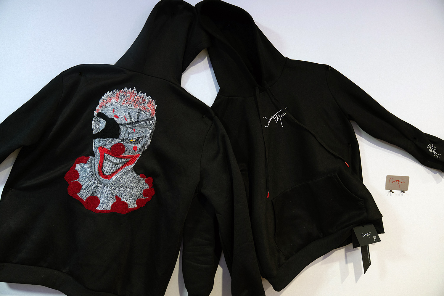 Black hoodies with clown design on back.
